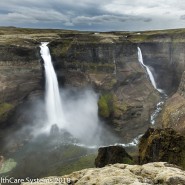 tall twin waterfalls into Icelandic canyon