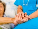 Nurse and patient holding hands